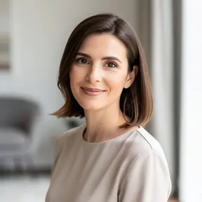Professional headshot of a French woman in her mid-30s, natural daylight, minimal and elegant interior background, relaxed and authentic smile, lifestyle portrait photography, soft tones, high resolution
