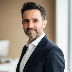 Professional headshot of a French man in his late 30s, bright natural lighting, soft beige interior background, confident and friendly expression, modern editorial portrait photography, realistic, high resolution
